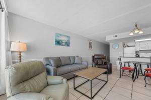 a living room with a couch and a table at Island Sunrise 362 by Youngs Suncoast in Gulf Shores