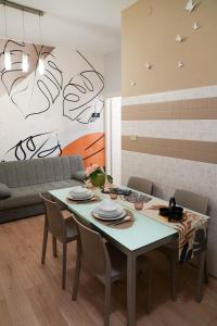 a living room with a table and a couch at Appartamenti Armida in Chioggia +29 photos