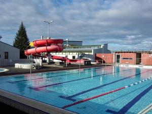 a large swimming pool with a red inflatable at Eldstó Art Café Guesthouse in Hvolsvöllur