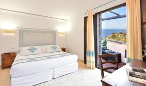 Postel nebo postele na pokoji v ubytování Arbatax Park Resort - Borgo Cala Moresca