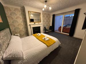 a bedroom with a bed with a mirror and a fireplace at Kenton Lane in Kenton