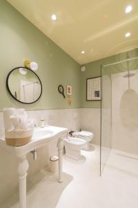 a bathroom with a sink and a toilet and a mirror at L'Ombra dell'Ulivo B&b in Marsala +47 photos