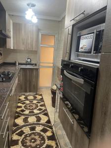 Η κουζίνα ή μικρή κουζίνα στο Cozy Comfort Flat , Madinaty