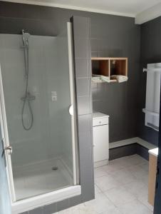 a shower with a glass door in a bathroom at Belle vue in Millau