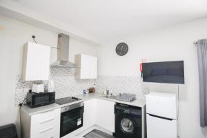 a kitchen with a sink and a stove and a microwave at Birmingham Central Luxury Suites in Birmingham +27 photos