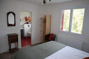 a bedroom with a bed and a window and a sink at Chambres grand confort - Maison independante in Monistrol-sur-Loire