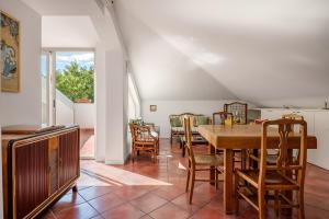 a kitchen and dining room with a table and chairs at Villa Rosaria in Giarre