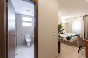 a bathroom with a toilet and a bedroom with a bed at Seven Stays New Cairo in Cairo +101 photos