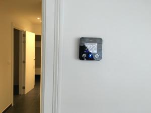 an open door with an alarm clock on it at Merida in Knokke-Heist