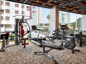 a gym with several tread machines in a building at ibis Styles Jakarta Simatupang in Jakarta