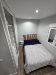 ein kleines Schlafzimmer mit einem Bett und einem Fenster in der Unterkunft Habitación privada con baño compartido en Madrid in Madrid
