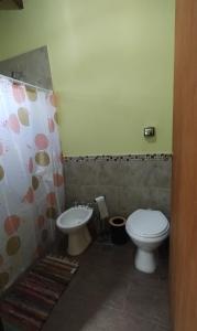a bathroom with a toilet and a sink at Cabaña Cina Cina in Villa Larca +8 photos