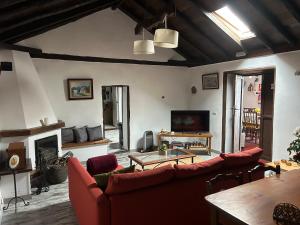 a living room with a red couch and a fireplace at Casa Lucia in Genovés