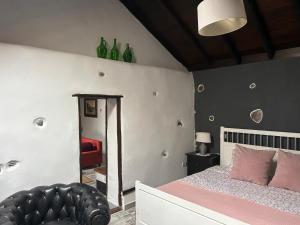 a bedroom with a bed with a mirror and a chair at Casa Lucia in Genovés
