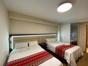 Postel nebo postele na pokoji v ubytování Hotel Sonccollay