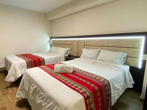 Postel nebo postele na pokoji v ubytování Hotel Sonccollay