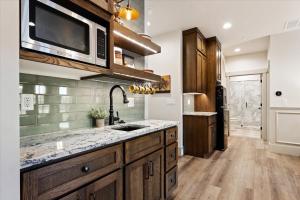 a kitchen with a sink and a microwave at The Oak Room - Newly Built 2B2B Loft Near Park City in Midway +10 photos