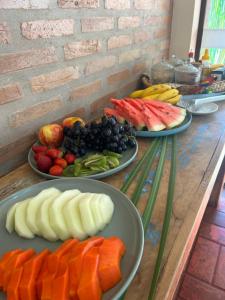 three plates of fruits and vegetables on a table at Pousada Tapajos Bonito in Bonito