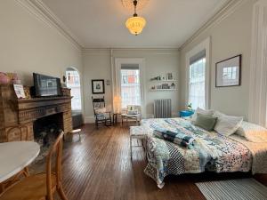 a bedroom with a bed and a living room at Townhouse in Portsmouth Downtown Historic District in Portsmouth