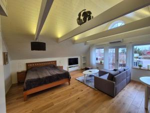 a bedroom with a bed and a couch at Toftahöjden 7 in Växjö