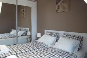 a bedroom with two twin beds and a mirror at Flat with Unforgettable View in Budapest