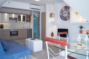 a living room and kitchen with a glass table and chairs at Flat with Unforgettable View in Budapest