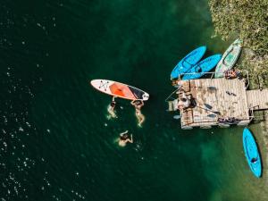 a group of surfboards on a dock in the water at Alpeta Agrotourism & Winery - Roshnik , Berat in Berat