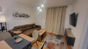a living room with a couch and a table at DivčiNova Luna in Divčibare