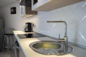 a kitchen with a sink in a counter top at Flat with Unforgettable View in Budapest