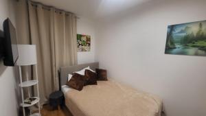 a bedroom with a bed with brown pillows on it at DivčiNova Luna in Divčibare