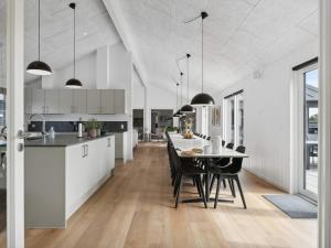 a kitchen and dining room with a table and chairs at 5 star holiday home in Idestrup in Marielyst