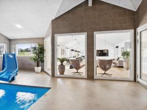 a living room with a pool and a slide at 5 star holiday home in Idestrup in Marielyst +15 photos