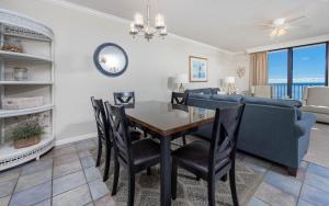 a dining room and living room with a table and a couch at Phoenix X 609 condo in Orange Beach