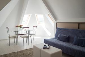 a living room with a blue couch and a table at Flat with Unforgettable View in Budapest
