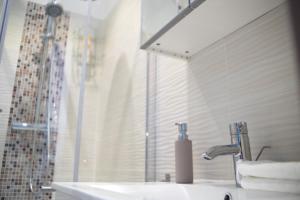 a bathroom with a sink and a shower at Flat with Unforgettable View in Budapest