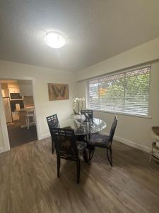 a dining room with a glass table and chairs at The Sunshine Haven in Delta +9 photos