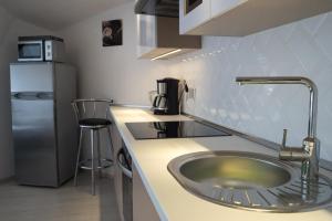a kitchen with a sink and a refrigerator at Flat with Unforgettable View in Budapest