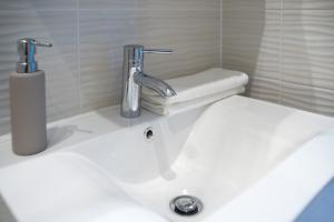 a bathroom sink with a faucet on top of it at Flat with Unforgettable View in Budapest