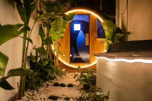 a wooden door with a mirror in a room with plants at El Parche Bilinga Beachside, Unit 5, Sleeps 6 in Gold Coast