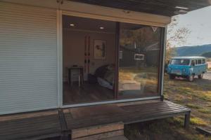 a screened in porch of a house with a van in it at Tiny house ikigai in Curacautín