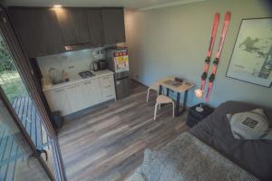 a living room with a kitchen and a table with a couch at Tiny house ikigai in Curacautín