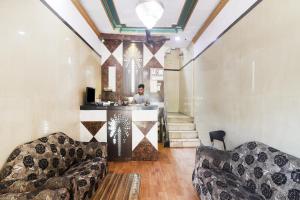 a man standing at a bar in a room at Hotel O Aadaab in Hyderabad