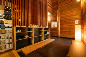 a room with wooden walls and a shelf with shoes at みみずく山荘 Mimizuku Lodge in Myoko +48 photos