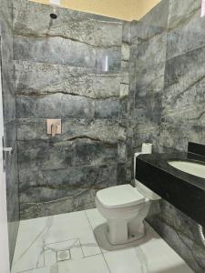 a bathroom with a toilet and a sink at Urban Center Apartamentos in Salto del Guairá