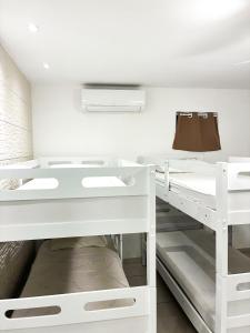 a room with white shelves and a bed at Fazenda Lagoa Azul in Silva Jardim