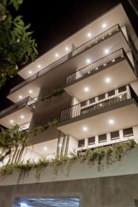 an apartment building with plants on the balconies at Double Suite Luxury Retreat 605 Tower in Cabo San Lucas