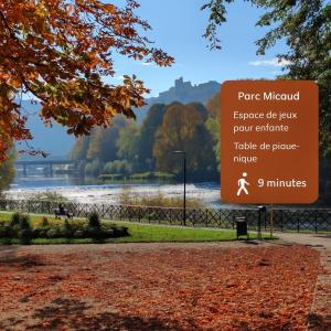 a sign in front of a park with a river at Le Loft - Place Flore - Besançon in Besançon