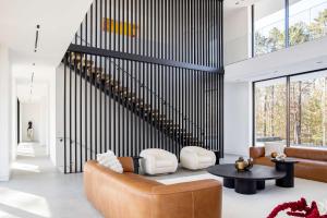 a living room with a couch and a table at Brightwater by Rove Sauna Pool & Outdoor Spaces in Freetown