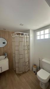 a bathroom with a shower and a toilet and a sink at Bright on the avenue in Mar del Plata