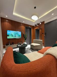 a living room with a couch and a flat screen tv at Rorex cozy cityview 1 bedroom apartment in Lekki +41 photos